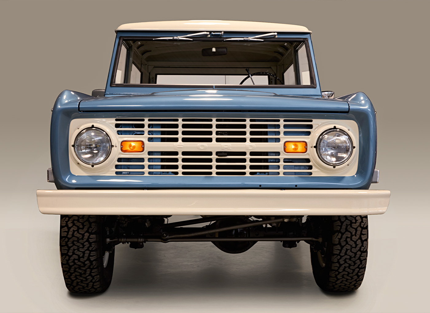 Front view of a studio staged shot of a light blue Bronco