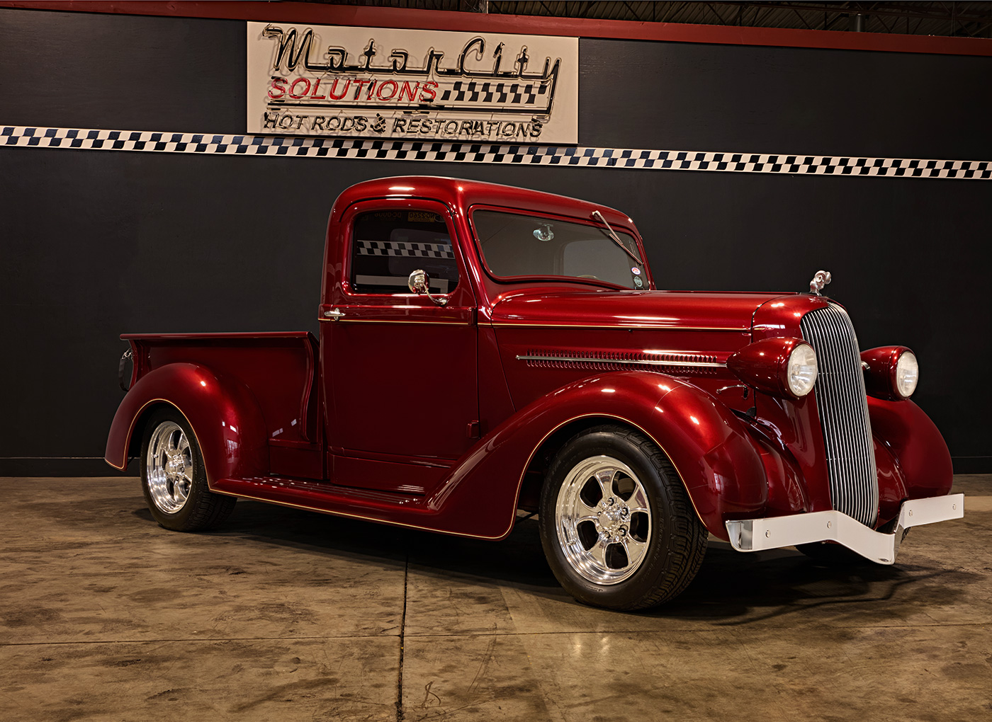 Angled view of a red Hot Rod parked inside the shop