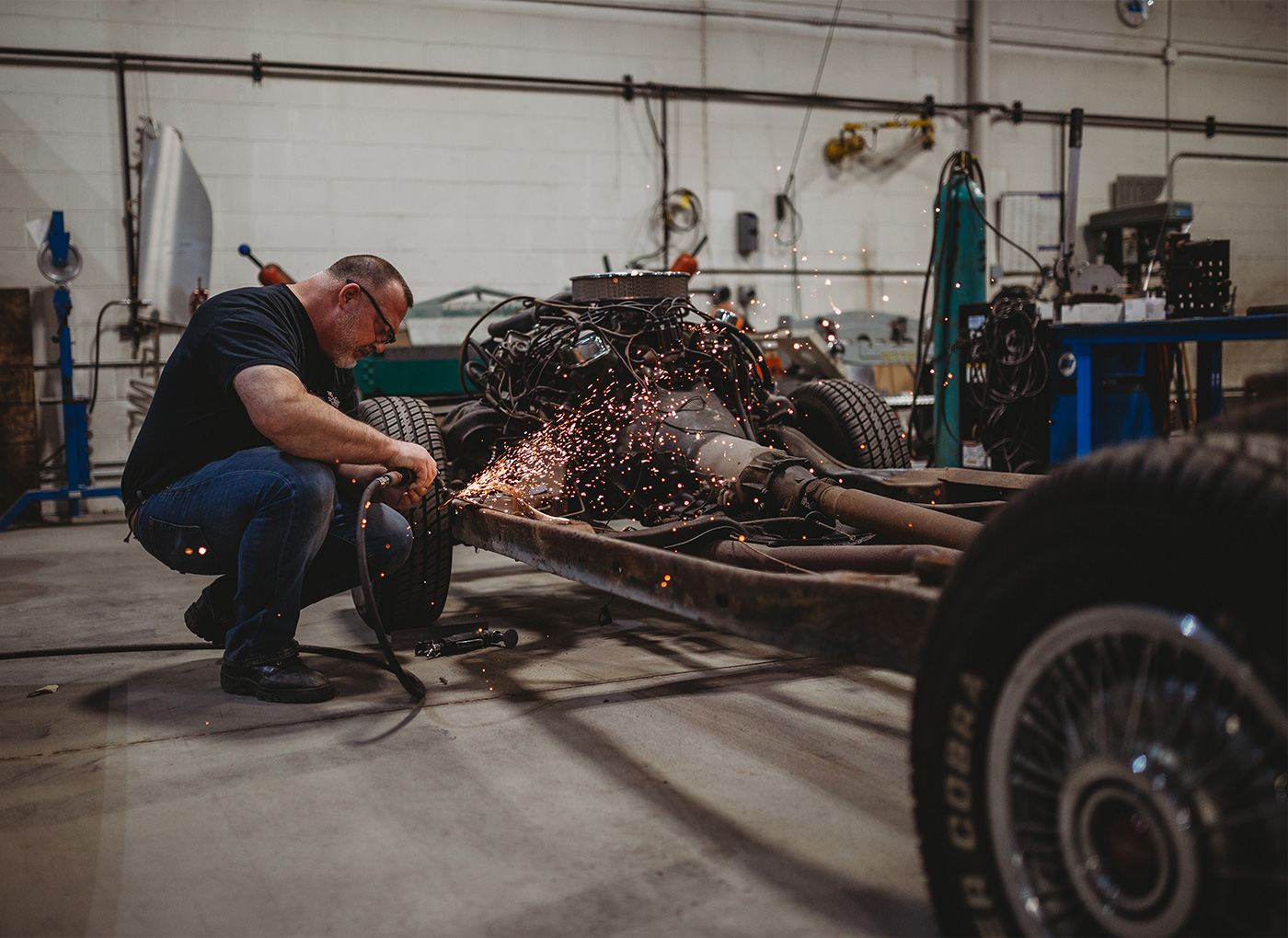 Man welding on a frame in the shop